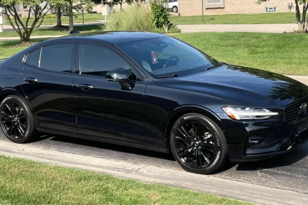 Side view of black sedan with tinted windows and polished exterior