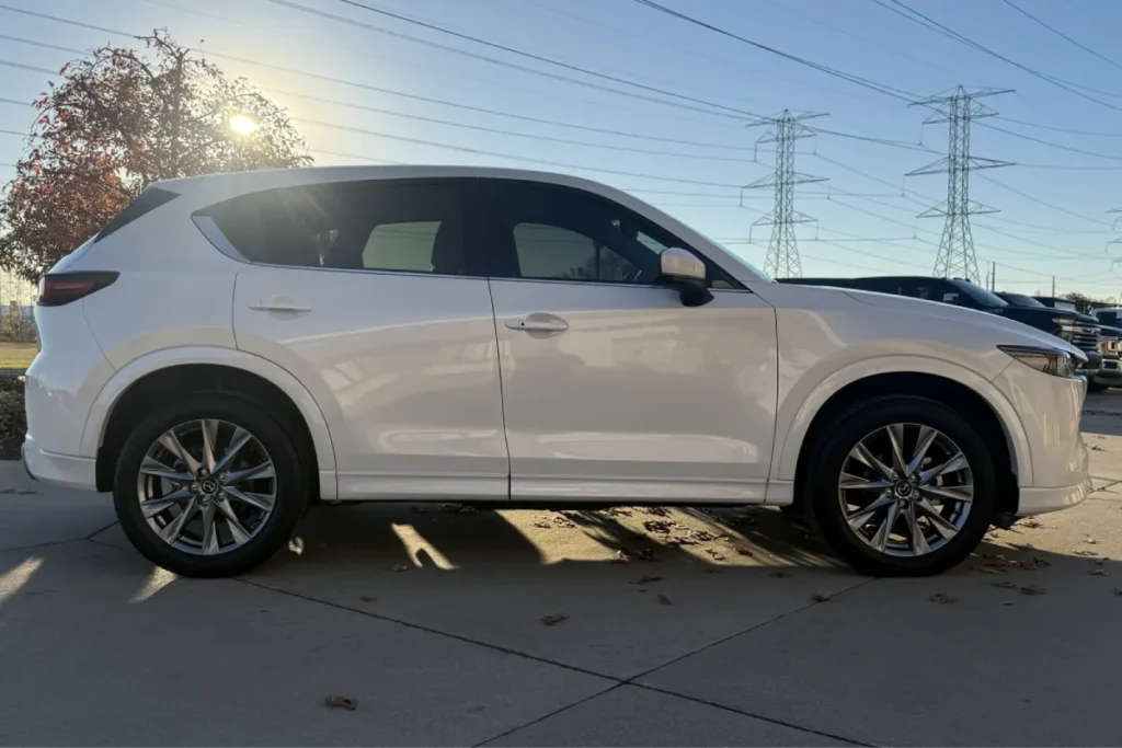 White car parked outdoors with tinted windows and clean glossy finish