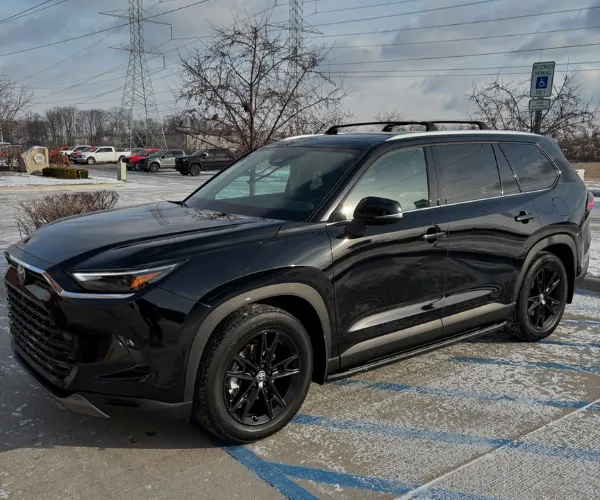 Black Toyota SUV parked outdoors after paint correction.