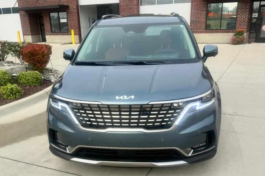 Front view of a Kia minivan after paint correction.