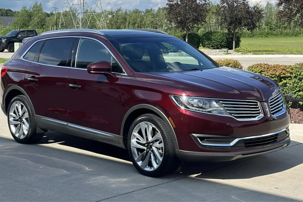 Maroon SUV with paint protection film on the front and side panels.