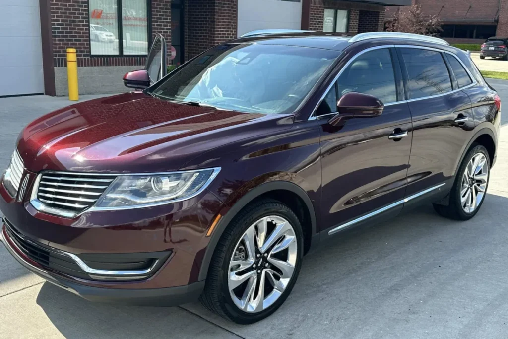 Maroon SUV protected with paint protection film for a glossy finish.