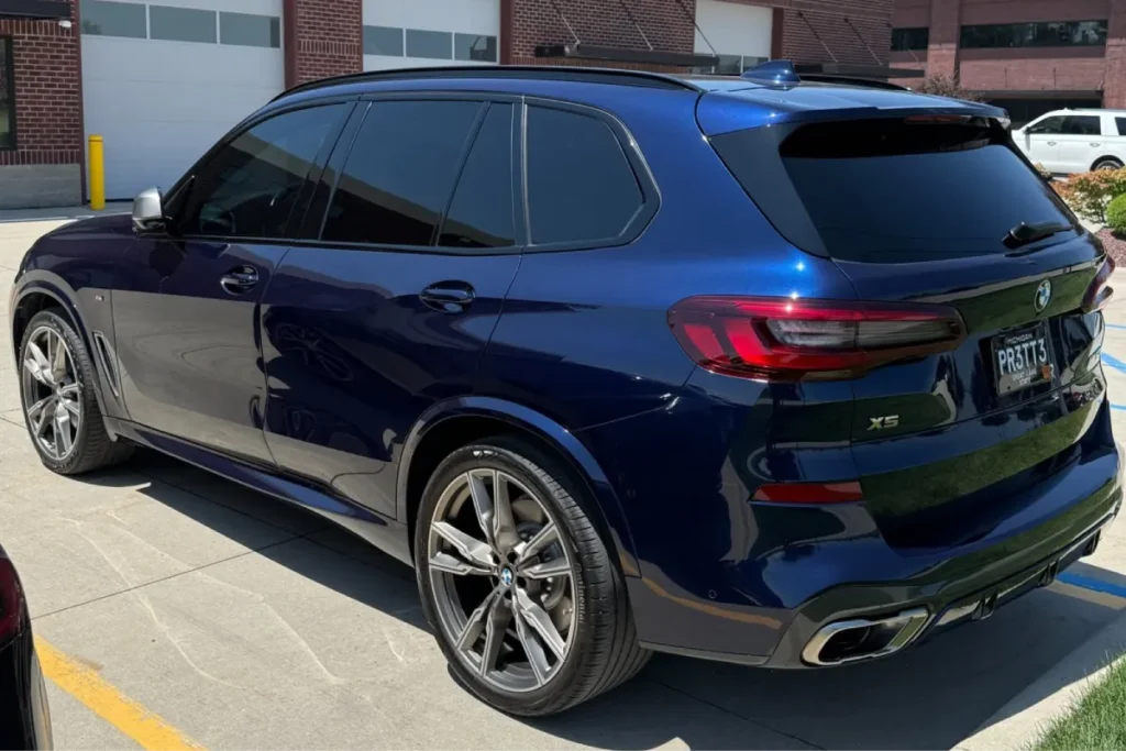 Blue BMW X5 with paint protection film and a glossy finish.