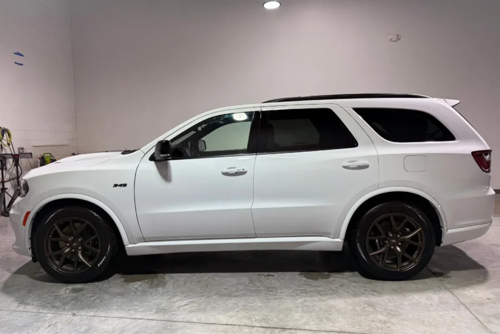 White Dodge Durango with professional window tint on side windows.